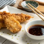 How to Eat Tempura Chicken? Golden crispy tempura chicken with dipping sauce and chopsticks